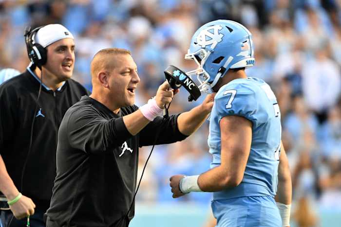 North Carolina offensive coordinator Phil Longo celebrates a big play with Tar Heel quarterback Sam Howell.